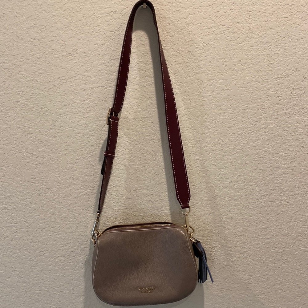 Kate Spade. Grey leather with wide maroon leather straps. Used once, like new.